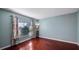 Relaxing bedroom featuring wood floors, a window with blinds and ample natural light at 1801 Summit Oaks Cir, Minneola, FL 34715