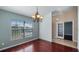 Dining room with beautiful floors, chandelier, and large window, with access to the entryway at 1801 Summit Oaks Cir, Minneola, FL 34715