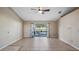 Open living room featuring tile floors and sliding glass doors to the pool area at 1801 Summit Oaks Cir, Minneola, FL 34715