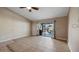 Living area featuring neutral walls, tile flooring and sliding glass doors to the pool at 1801 Summit Oaks Cir, Minneola, FL 34715