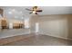 Spacious living room featuring tile flooring, a ceiling fan, and views into the kitchen area at 1801 Summit Oaks Cir, Minneola, FL 34715