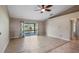 Bright living room showcasing tile floors and sliding glass doors to the outdoor area at 1801 Summit Oaks Cir, Minneola, FL 34715