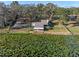 Scenic aerial shot of lakeside home featuring mature trees, and lush aquatic vegetation at 18944 Bates Ave, Eustis, FL 32736