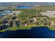 An aerial view of the community, featuring a lakefront property, surrounded by lush greenery, and scenic lake views at 18944 Bates Ave, Eustis, FL 32736