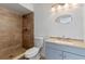 Bathroom with a walk-in shower and granite countertop vanity at 18944 Bates Ave, Eustis, FL 32736