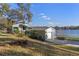 This cozy home with attached garage is nestled on a lush hillside with beautiful waterfront views at 18944 Bates Ave, Eustis, FL 32736