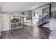 Open-concept living room featuring a modern kitchen and a wooden staircase at 18944 Bates Ave, Eustis, FL 32736