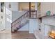 Cozy living room with a rustic fireplace and staircase to the second floor at 18944 Bates Ave, Eustis, FL 32736