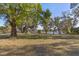 Spacious yard with large trees and a view of the lake at 18944 Bates Ave, Eustis, FL 32736