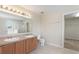 Primary bathroom featuring double sinks with a walk-in shower and a soaking tub at 201 Andover Dr, Davenport, FL 33897