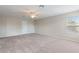 Bright bedroom with carpeted floors, a ceiling fan, a window and a closed door at 201 Andover Dr, Davenport, FL 33897