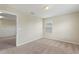 A bright, neutral bedroom featuring carpet, window, and a door to another room at 201 Andover Dr, Davenport, FL 33897