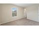 A neutral bedroom features carpet, a bright window, and a door at 201 Andover Dr, Davenport, FL 33897