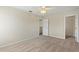 Bedroom with neutral walls, carpet, ceiling fan and an open door at 201 Andover Dr, Davenport, FL 33897