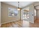 Bright dining room features wood floors and sliding glass doors that lead to screened porch at 201 Andover Dr, Davenport, FL 33897