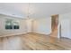 Bright living room featuring hardwood floors, natural light, and an adjacent staircase at 201 Andover Dr, Davenport, FL 33897