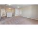 Carpeted living room featuring open doorways and a partial staircase with a white banister at 201 Andover Dr, Davenport, FL 33897