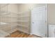 Spacious pantry with shelving providing ample storage space, located off laundry room at 201 Andover Dr, Davenport, FL 33897