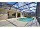 Inviting outdoor area with a screened-in private pool at 201 Andover Dr, Davenport, FL 33897