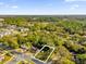 Aerial view of a corner homesite lot surrounded by established trees in a vibrant community at 2030 N Highland St, Mount Dora, FL 32757