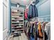 A walk-in closet with shelving, rods, and storage solutions offers ample space for clothing and accessories at 215 Elm Ct, Kissimmee, FL 34759