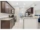 Well-lit kitchen featuring granite counters, stainless steel appliances, and tile flooring. Dining room view at 215 Elm Ct, Kissimmee, FL 34759