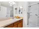 Bathroom featuring a shower, glass door, and wood vanity at 2245 Hanover Ter, The Villages, FL 32162