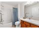 Bathroom with shower/tub combo, wood vanity and ample lighting at 2245 Hanover Ter, The Villages, FL 32162