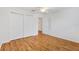 Bright bedroom featuring wood floors, a ceiling fan, and a closet at 2245 Hanover Ter, The Villages, FL 32162