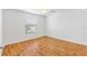 Bright bedroom featuring wood floors, a window, and white walls at 2245 Hanover Ter, The Villages, FL 32162