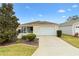 Charming single-story home with a well-manicured lawn and a two-car garage at 2245 Hanover Ter, The Villages, FL 32162