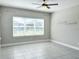 Bright bedroom features neutral walls, a ceiling fan, and large windows offering an airy space at 2313 Hamilton Ridge Road, Clermont, FL 34715