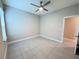 Spacious bedroom with neutral walls, tile floor, and ceiling fan offers a versatile living space at 2313 Hamilton Ridge Road, Clermont, FL 34715