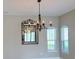 Dining room showing a chandelier with a decorative mirror reflecting a view of the kitchen at 2313 Hamilton Ridge Road, Clermont, FL 34715