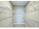 Walk-in closet features white wire shelving and tile flooring for organized storage at 2313 Hamilton Ridge Road, Clermont, FL 34715