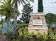 Resort Clubhouse sign surrounded by beautiful tropical landscaping and palm trees at 2313 Hamilton Ridge Road, Clermont, FL 34715