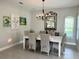 Bright dining room with a large window, modern chandelier, and seating for six at 2313 Hamilton Ridge Road, Clermont, FL 34715