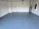 Spacious garage features epoxy flooring, ample lighting, and plenty of room for parking at 2313 Hamilton Ridge Road, Clermont, FL 34715