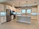 Modern kitchen featuring white cabinetry, stainless steel appliances, and a large center island at 2313 Hamilton Ridge Road, Clermont, FL 34715