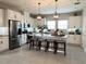 Well-lit kitchen with stainless steel appliances, center island, and breakfast bar seating at 2313 Hamilton Ridge Road, Clermont, FL 34715