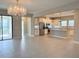 Open concept living room with tile floors flowing into a modern kitchen with stainless appliances at 2313 Hamilton Ridge Road, Clermont, FL 34715