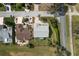 Aerial view of a well-maintained home with landscaped yard, surrounded by lush greenery and a quiet neighborhood at 25274 Lost Oak Cir, Leesburg, FL 34748