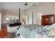 Relaxing bedroom featuring a four-poster bed, TV and lots of natural light at 25274 Lost Oak Cir, Leesburg, FL 34748