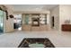 Bright living room featuring a custom built-in hutch with display cabinets, and views to the Florida room at 25274 Lost Oak Cir, Leesburg, FL 34748