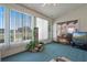 Sunroom with large windows with vertical blinds, indoor greenery, and vintage television set, creating a cozy space at 25274 Lost Oak Cir, Leesburg, FL 34748