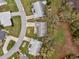 Aerial view of home in a quiet neighborhood, showcasing mature landscaping and well-maintained surroundings at 27003 Racquet Cir, Leesburg, FL 34748