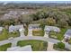 Lovely aerial view of a single Gathering home in a quiet neighborhood with mature trees at 27003 Racquet Cir, Leesburg, FL 34748