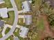 Aerial view of home in a quiet neighborhood, showcasing mature landscaping and well-maintained surroundings at 27003 Racquet Cir, Leesburg, FL 34748