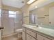 Practical bathroom with a shower, toilet, vanity with sink, and neutral tiling at 27003 Racquet Cir, Leesburg, FL 34748