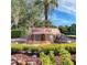 The Highland Lakes stone community sign sits atop a serene fountain surrounded by lush greenery at 27003 Racquet Cir, Leesburg, FL 34748